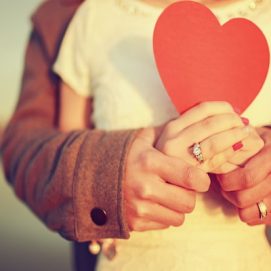 2017Love_Couple_in_love_holds_a_red_heart_of_paper_118797_23